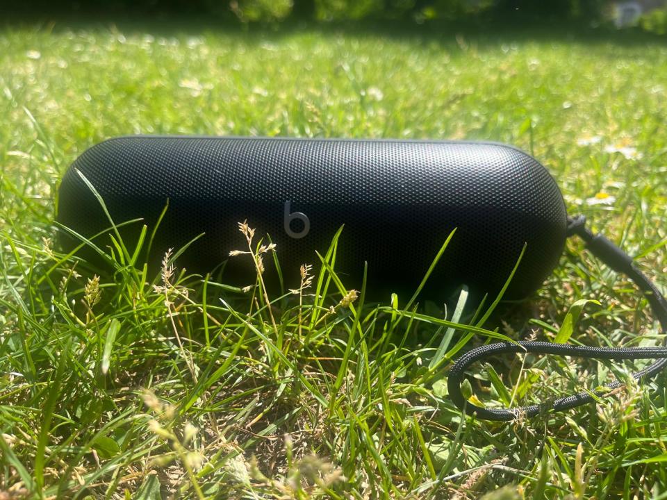 Black Beats Pill speaker in the grass.